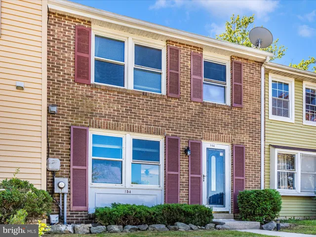 a view of a brick building next to a yard