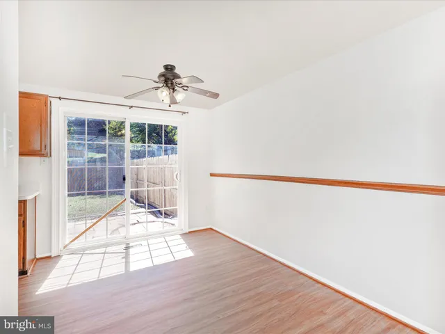 a view of a livingroom with wooden floor and a window