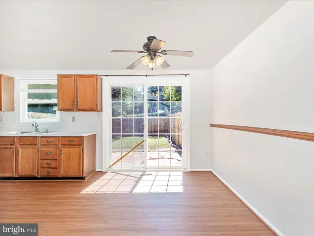 a view of a kitchen with wooden floor and electronic appliances