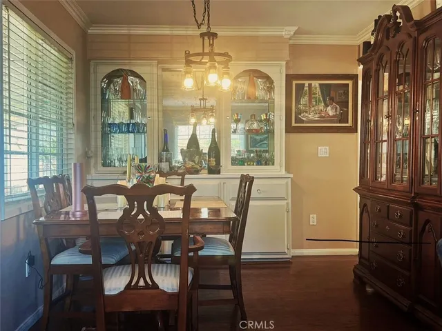 a view of a dining room with furniture and chandelier