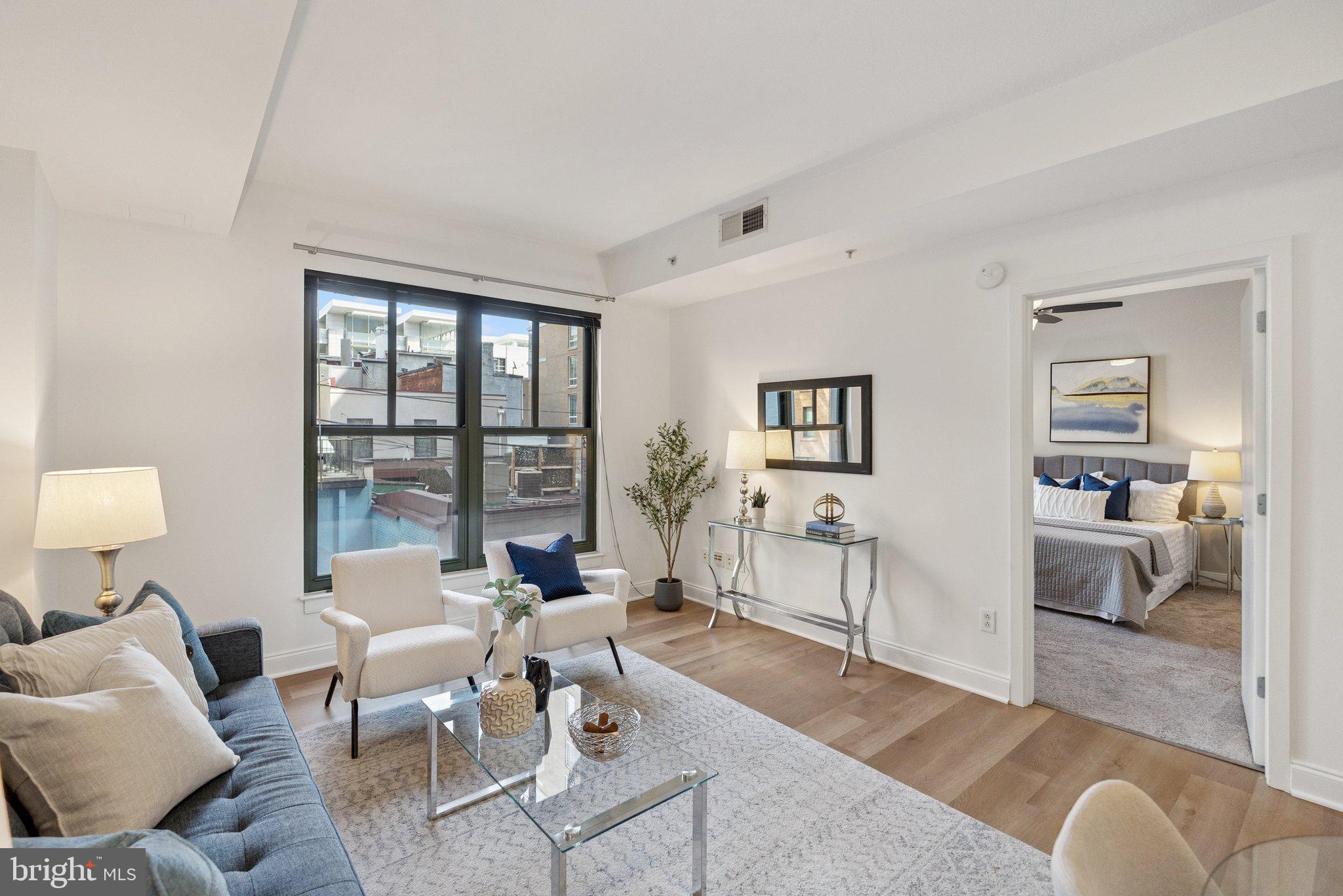 910 M Street Northwest, Unit 202 Washington, DC 20001 - Photo 11 of 27 a living room with furniture and a window