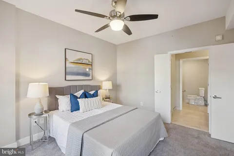 a bedroom with bed and a chandelier