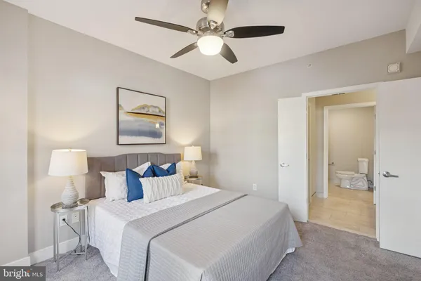 a bedroom with bed and a chandelier