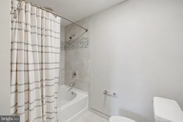a bathroom with a shower curtain and a sink