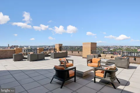 a terrace with outdoor seating city view and barbeque oven