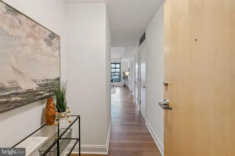 a view of a hallway with wooden floor and entryway