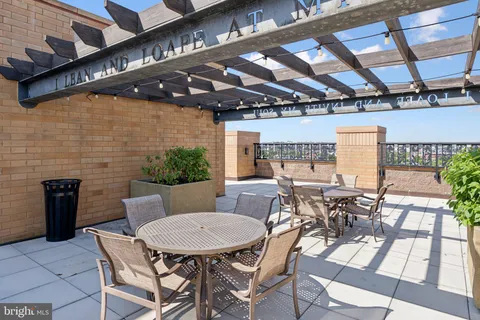 a view of a patio with table and chairs and potted plants
