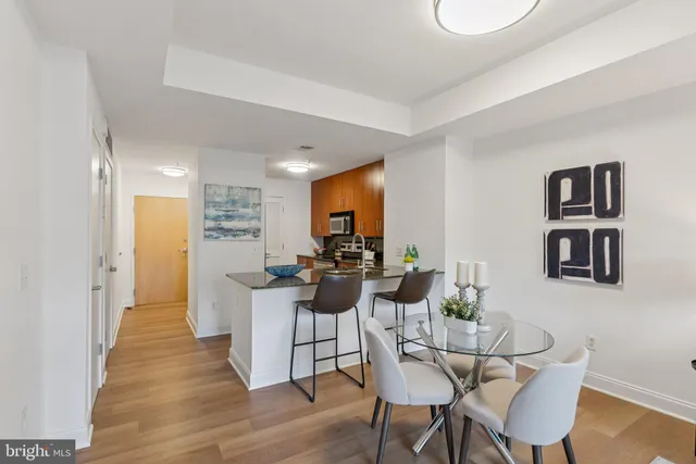 a view of a dining room with furniture and wooden floor