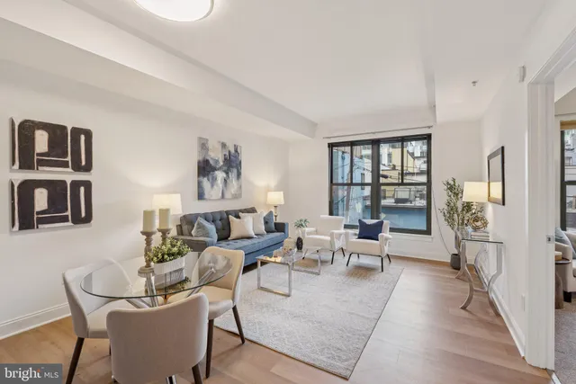 a living room with furniture and large window