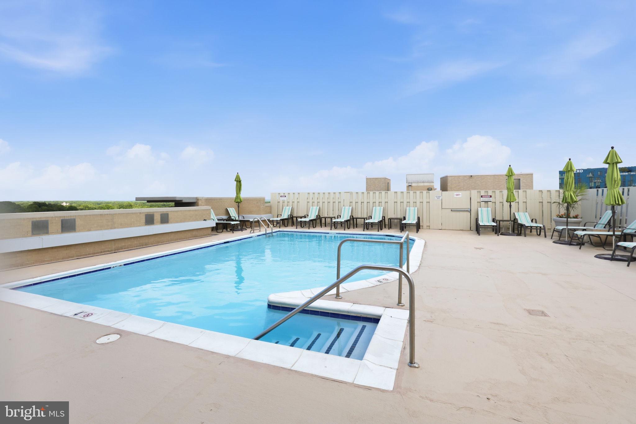 11800 Sunset Hills Road, Unit 218 Reston, VA 20190 - Photo 6 of 38 a view of swimming pool outdoor seating and city view