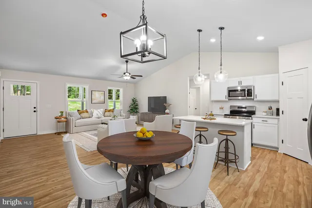 a view of kitchen with cabinets table and chairs