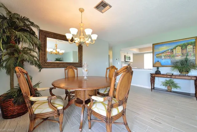 a dining room with furniture a large window and wooden floor