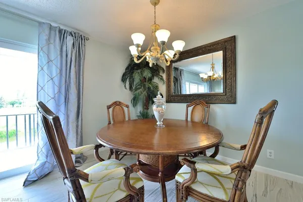 a dining room with furniture and chandelier