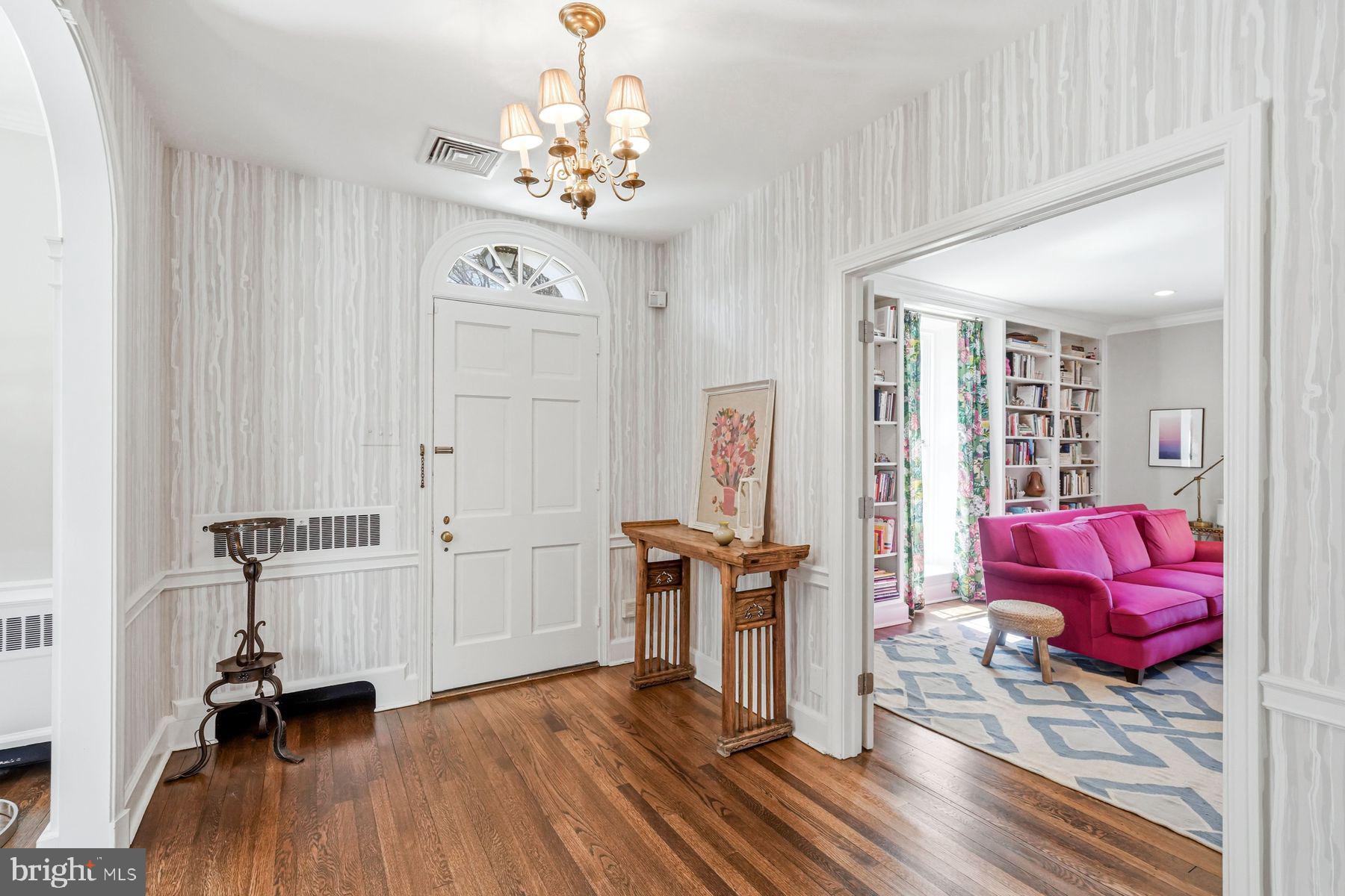 828 Black Rock Road Gladwyne, PA 19035 - Photo 15 of 68 a view of a livingroom with furniture wooden floor windows and a chandelier