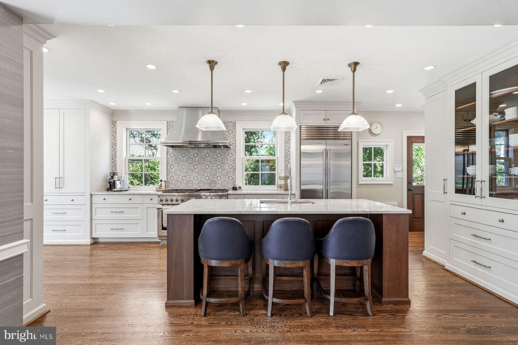 828 Black Rock Road Gladwyne, PA 19035 - Photo 26 of 68 a kitchen with stainless steel appliances granite countertop a table chairs stove and wooden cabinets