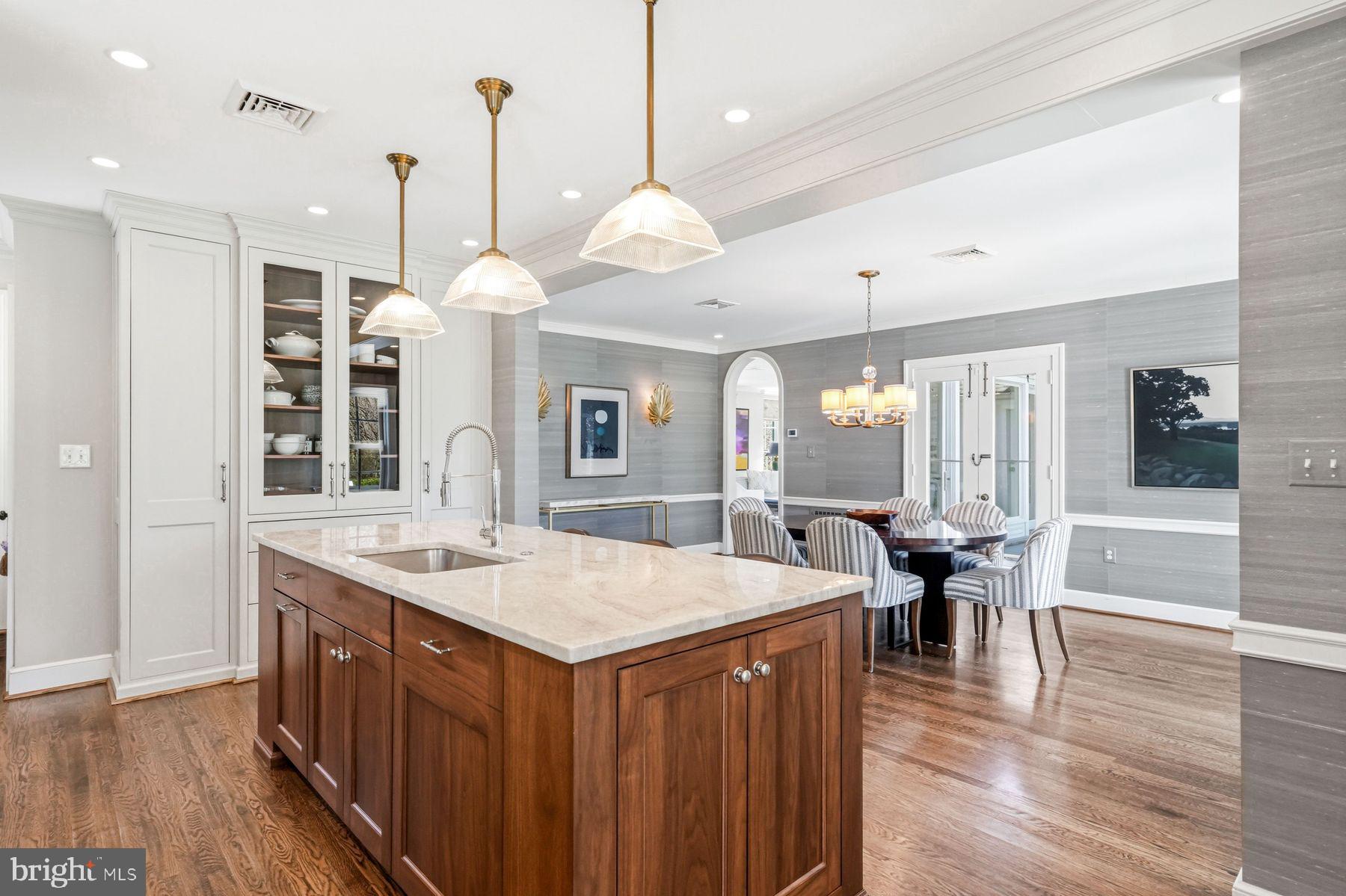 828 Black Rock Road Gladwyne, PA 19035 - Photo 29 of 68 a kitchen with a dining table chairs sink and wooden floor