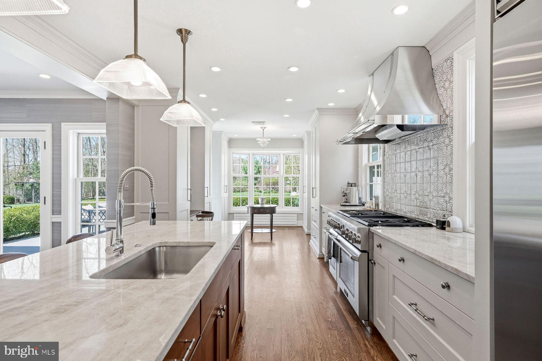 828 Black Rock Road Gladwyne, PA 19035 - Photo 31 of 68 a kitchen with granite countertop a stove a sink a refrigerator and a wooden floor