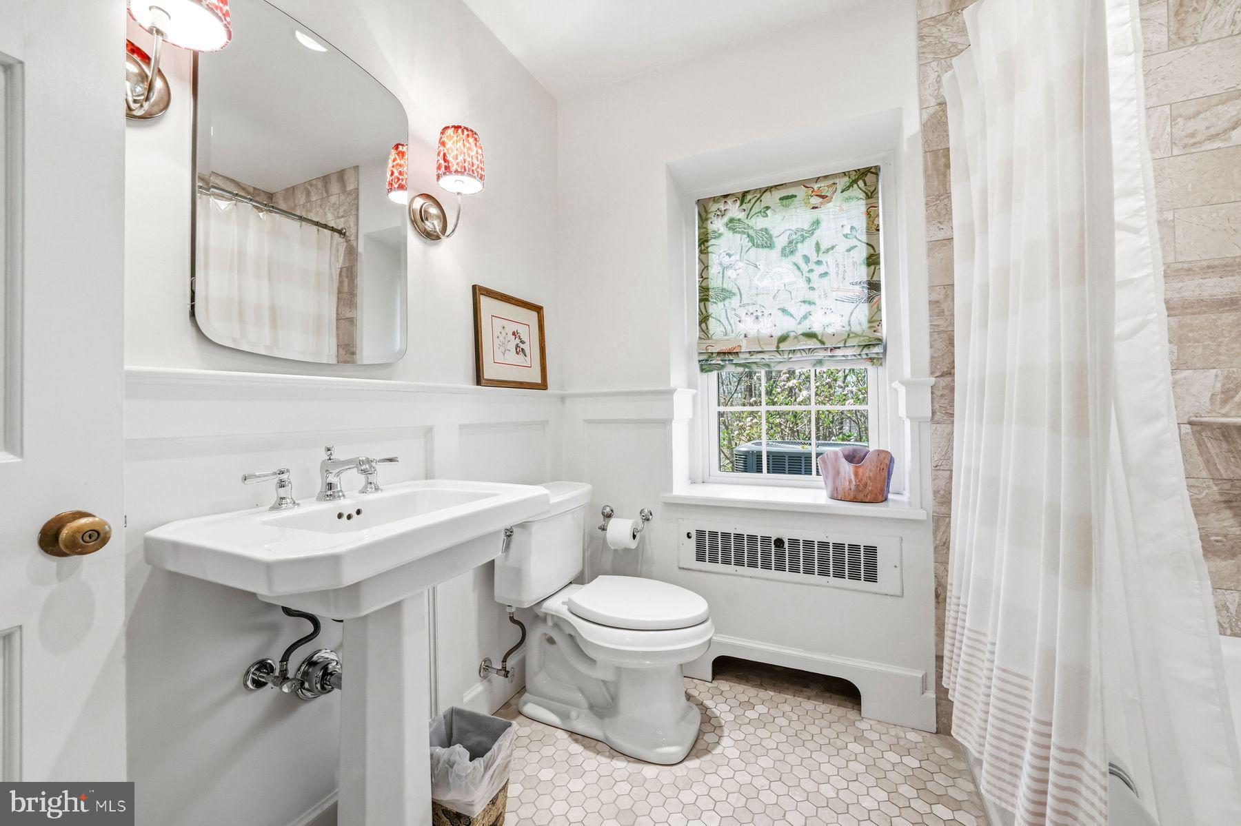 828 Black Rock Road Gladwyne, PA 19035 - Photo 46 of 68 a bathroom with a sink a toilet a mirror and a window