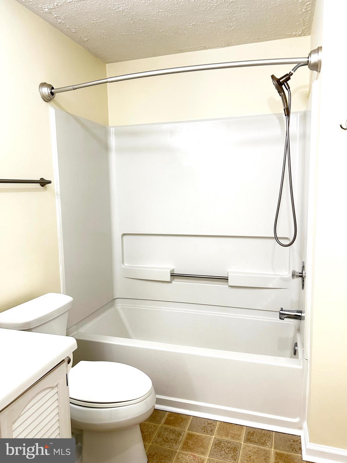 803 J Stratford Way, Unit 1100J Frederick, MD 21701 - Photo 12 of 16 a bathroom with a shower a toilet and a shower