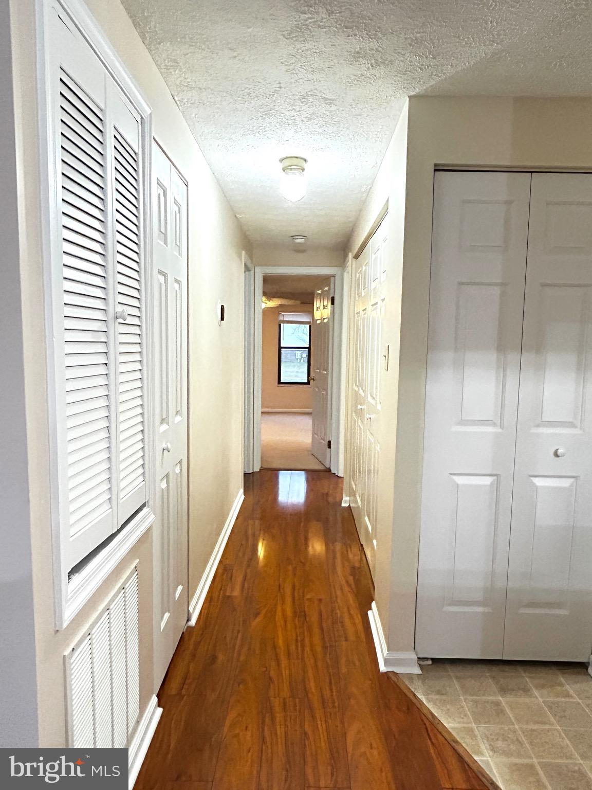 803 J Stratford Way, Unit 1100J Frederick, MD 21701 - Photo 8 of 16 a view of a hallway with wooden floor and staircase