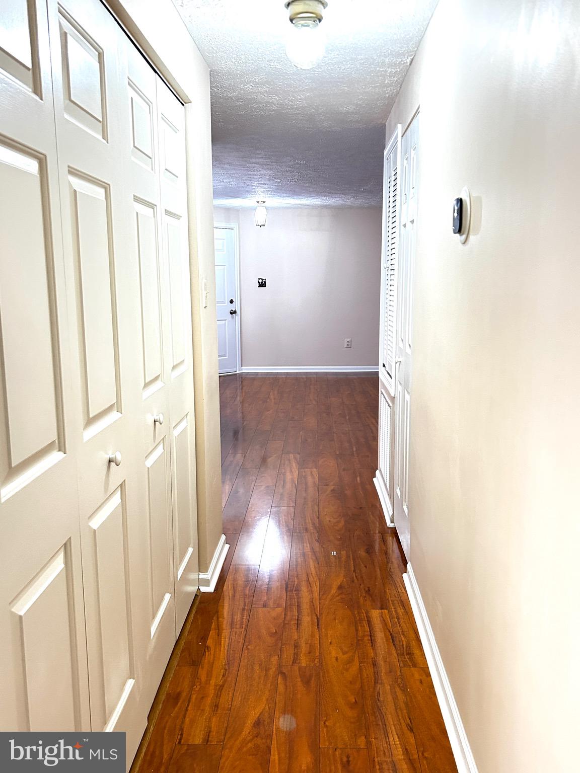 803 J Stratford Way, Unit 1100J Frederick, MD 21701 - Photo 9 of 16 a view of a hallway with wooden floor