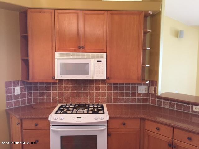 205 Cedar Ridge Circle St. Augustine, FL 32080 - Photo 12 of 29 a kitchen with a stove and cabinets