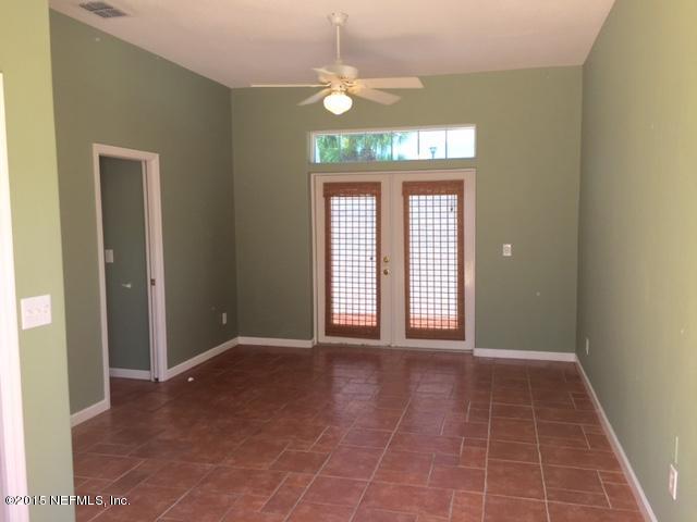 205 Cedar Ridge Circle St. Augustine, FL 32080 - Photo 16 of 29 a view of a room with a chandelier fan and a large window