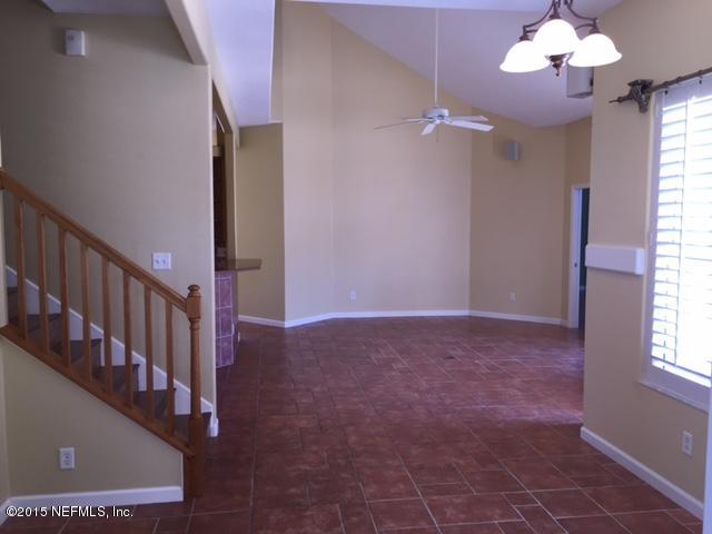 205 Cedar Ridge Circle St. Augustine, FL 32080 - Photo 8 of 29 a view of an empty room with chandelier fan and a window