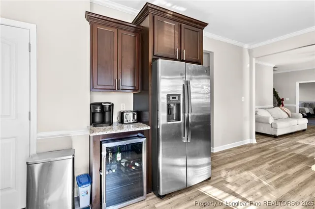 a kitchen with stainless steel appliances granite countertop a refrigerator and a stove