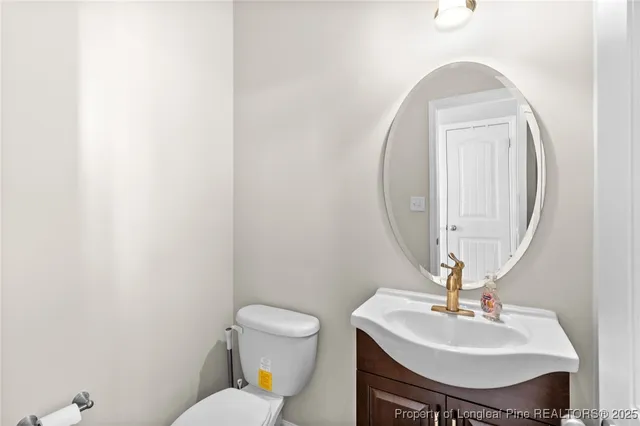 a bathroom with a sink mirror and toilet