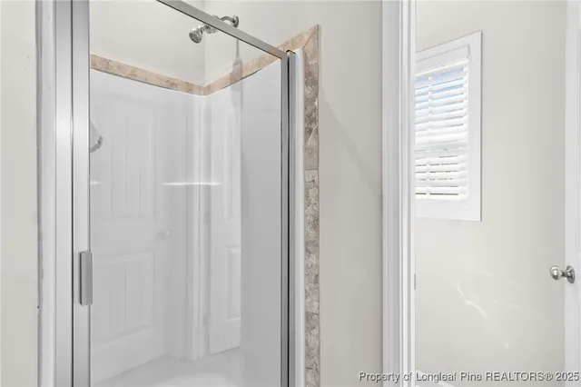 a bathroom with a shower and a window