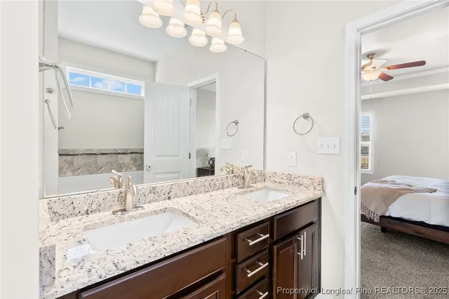 a bathroom with a granite countertop sink and a mirror