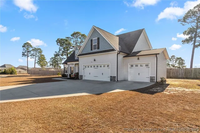 a view of a house with a yard and garage