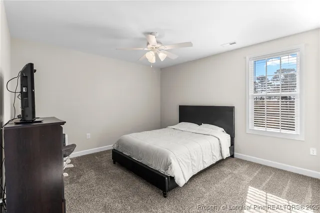 a bedroom with a bed lamp and a window