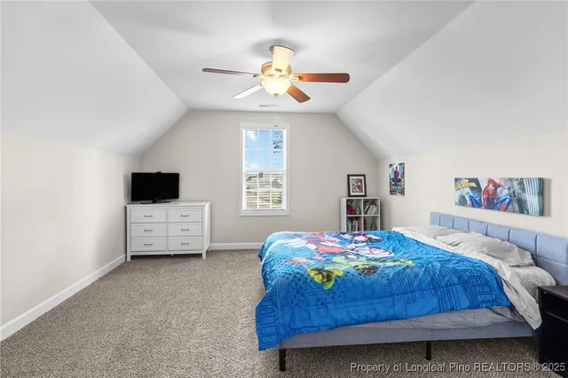 a bedroom with a bed and a tv