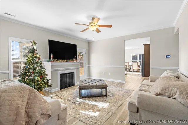 a living room with furniture a fireplace and a flat screen tv