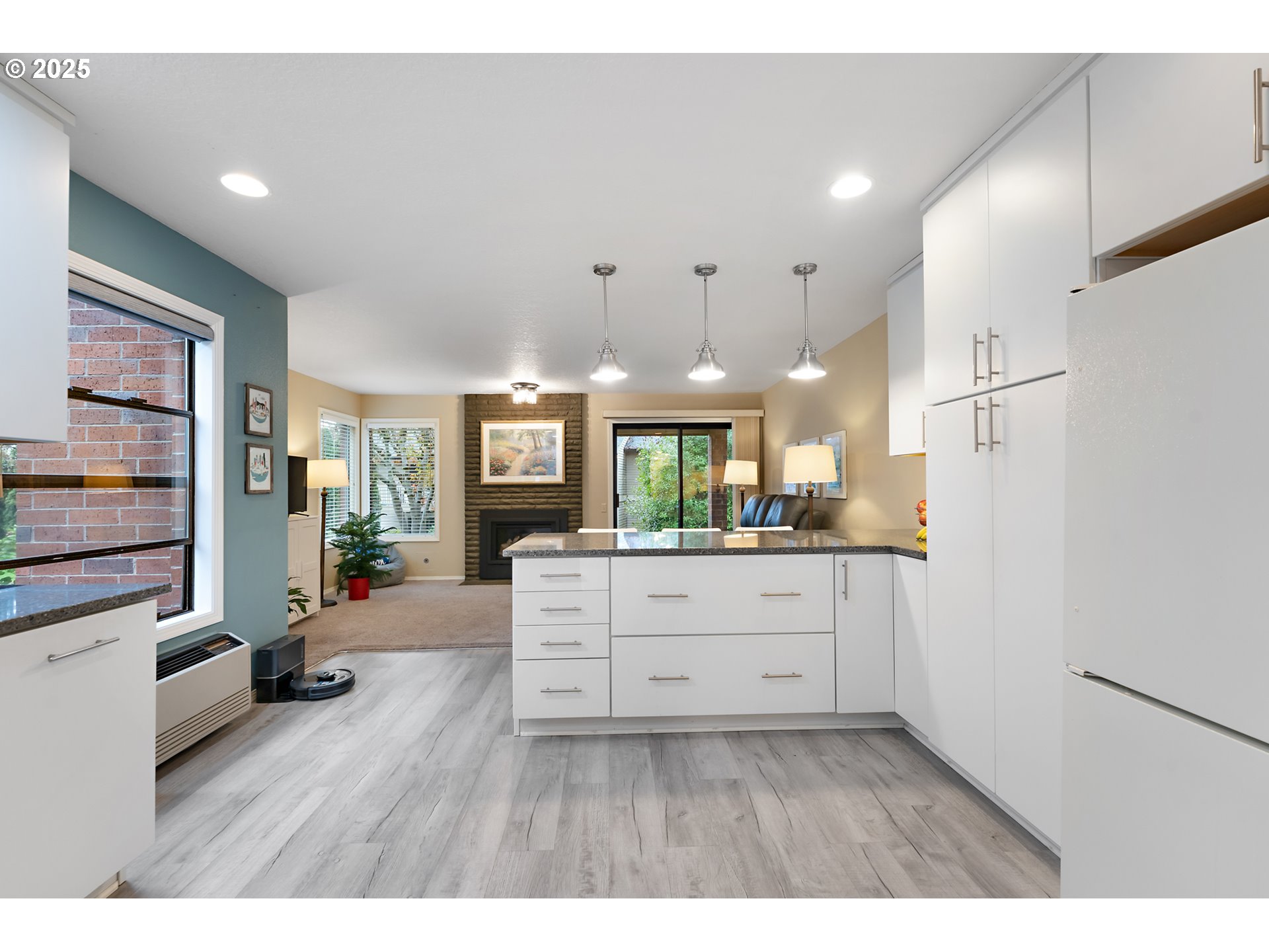 15514 Southwest 114th Court, Unit 61 Tigard, OR 97224 - Photo 11 of 35 a kitchen with white cabinets and refrigerator