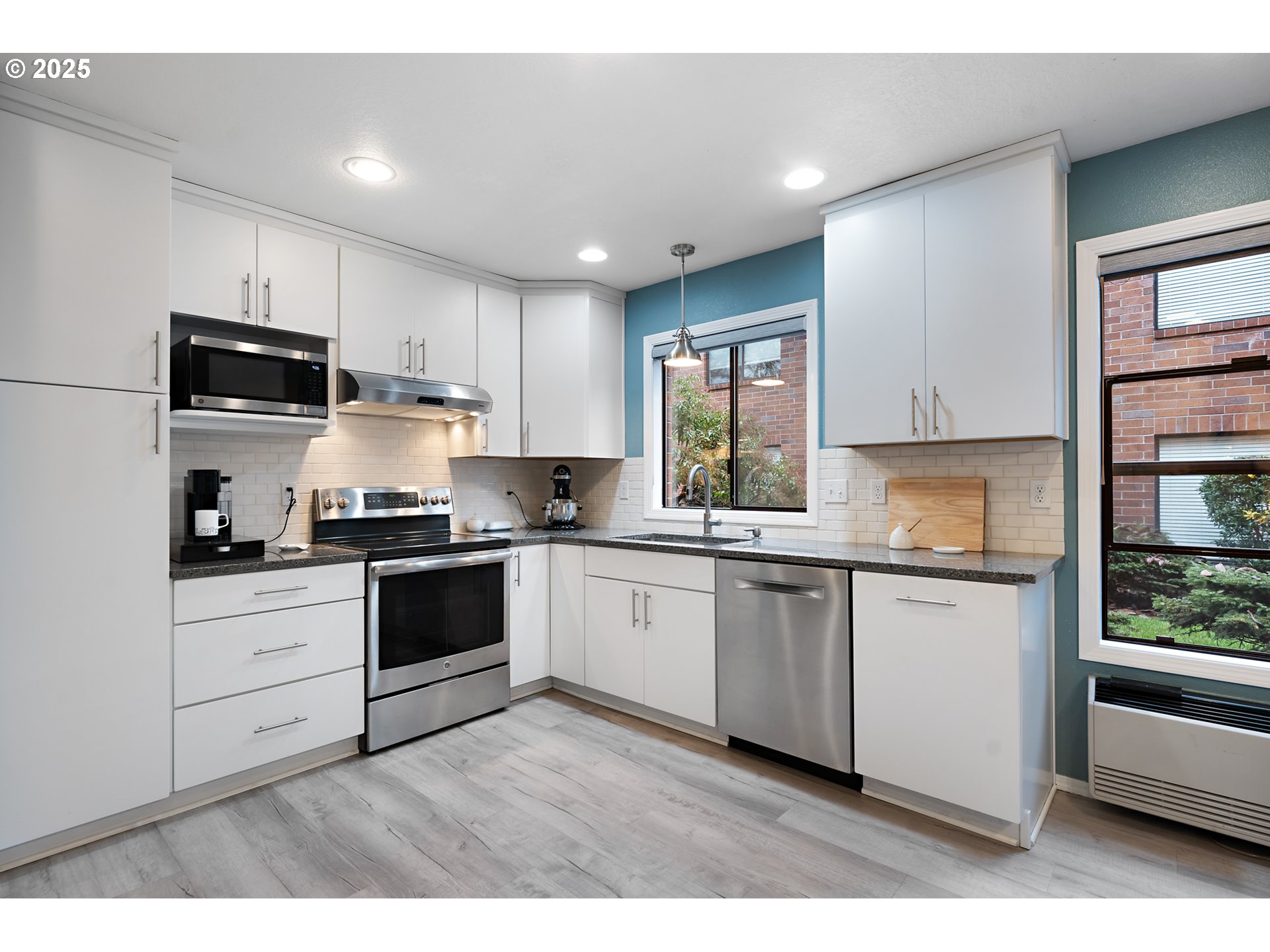 15514 Southwest 114th Court, Unit 61 Tigard, OR 97224 - Photo 14 of 35 a kitchen with granite countertop white cabinets and white appliances