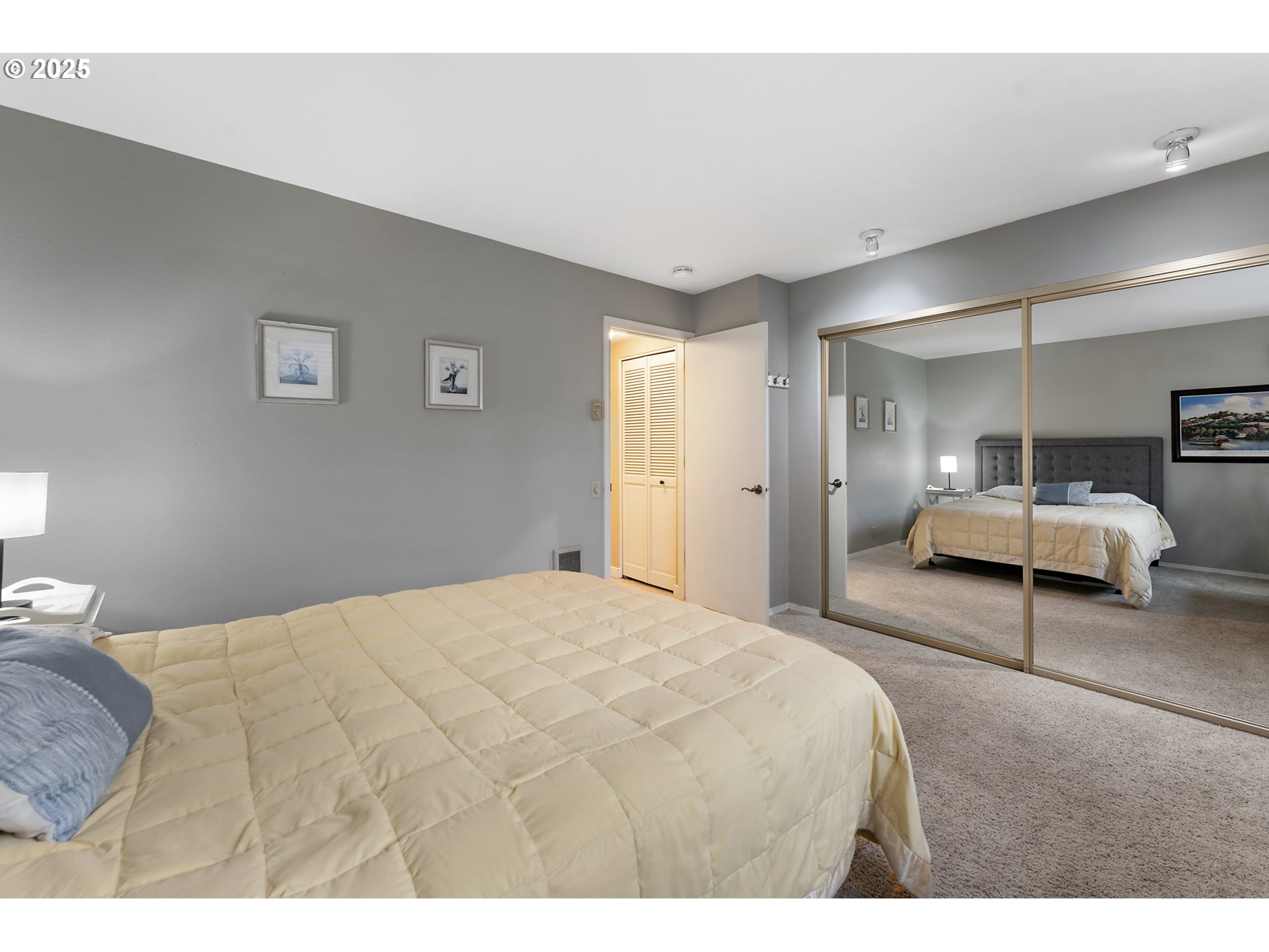 15514 Southwest 114th Court, Unit 61 Tigard, OR 97224 - Photo 18 of 35 a bedroom with a bed and a large mirror