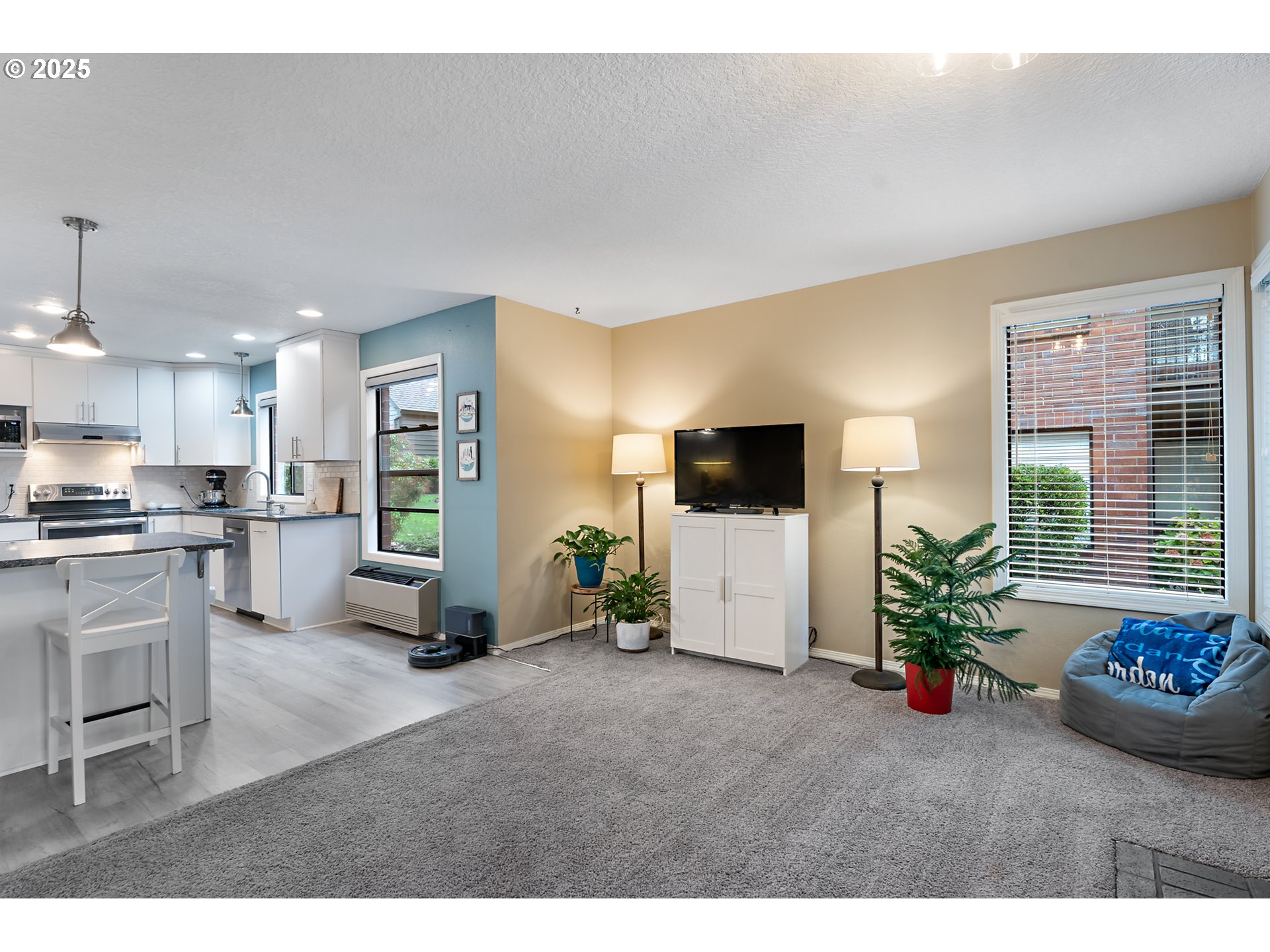 15514 Southwest 114th Court, Unit 61 Tigard, OR 97224 - Photo 7 of 35 a living room with furniture and a flat screen tv