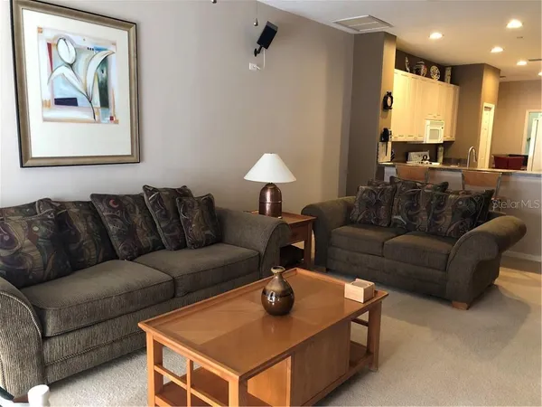 a living room with furniture a couch and a window