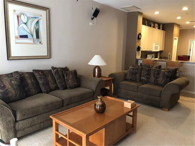 a living room with furniture a couch and a window