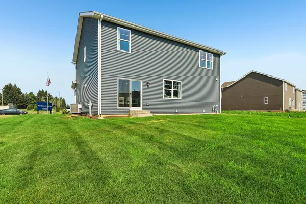 a front view of house with yard and green space
