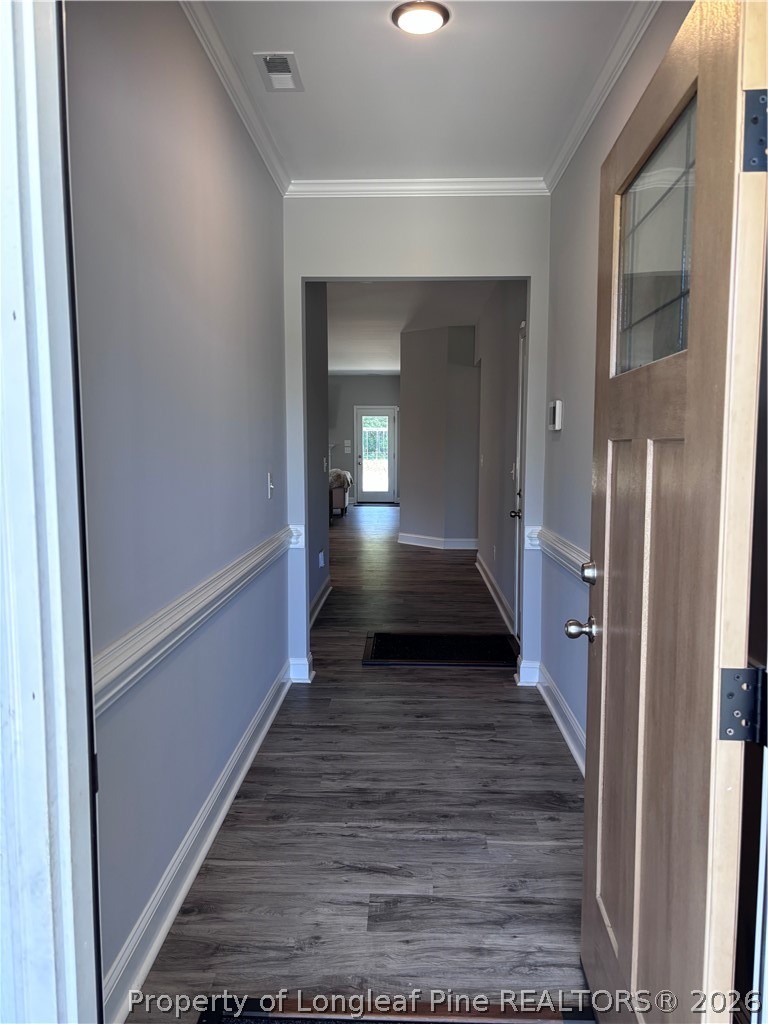 7720 Rufus Johnson Road Fayetteville, NC 28306 - Photo 4 of 50 a view of a hallway view with wooden floor and staircase