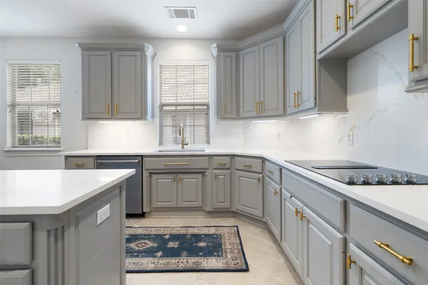 a kitchen with a sink a refrigerator and cabinets