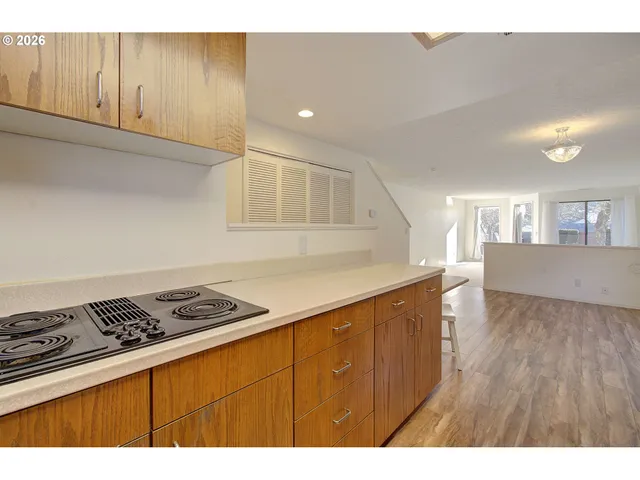 a kitchen with granite countertop a stove and cabinets
