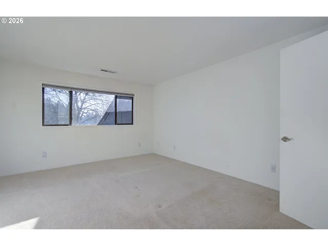 a view of an empty room with windows