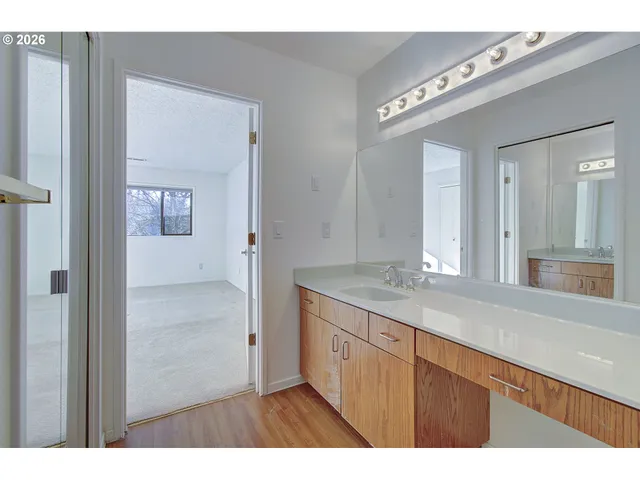 a bathroom with a granite countertop sink and a mirror