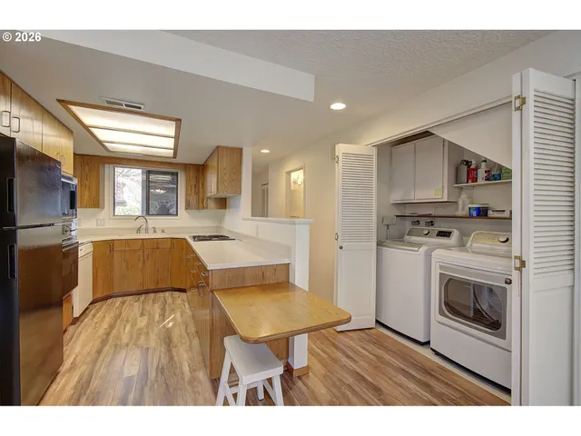 a view of kitchen with cabinets and wooden floor