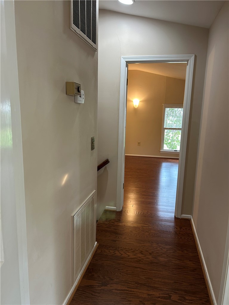110 North Broad Street Pendleton, SC 29670 - Photo 25 of 32 Rich hardwood flooring leads into this inviting interior hallway, hinting at comfortable living spaces beyond.